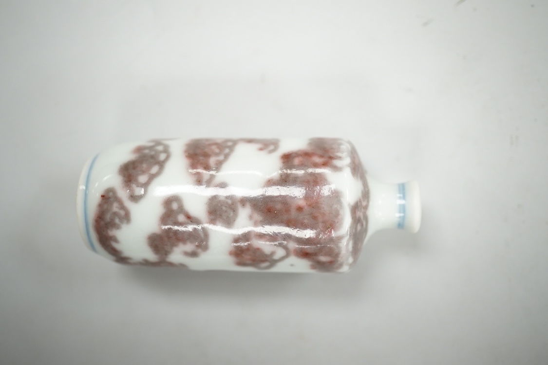 A Chinese cinnabar lacquer snuff bottle, a glass overlay snuff bottle and an underglaze copper red snuff bottle-9cm high (3)